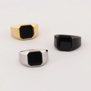 Detailed macro shot of vintage square black onyx rings in gold, silver, and black finish