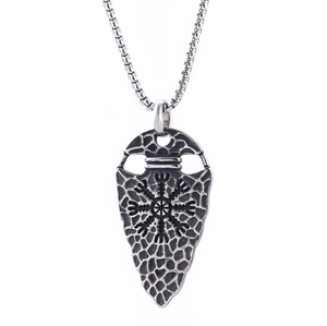 Detail of Viking Vegvisir compass pendant with ancient runes and aged silver texture