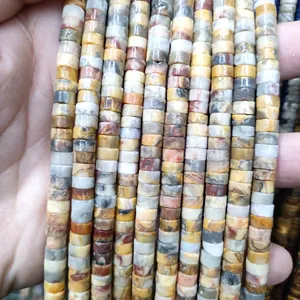 Macro shot of 3x6mm natural tiger eye stone heishi spacers for DIY jewelry making
