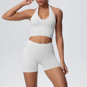 Close-up of white ribbed seamless yoga set showing the high-waist shorts and halter crop top