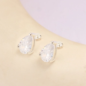 Macro shot of S925 sterling silver stud earrings with pear-cut clear zircon stones