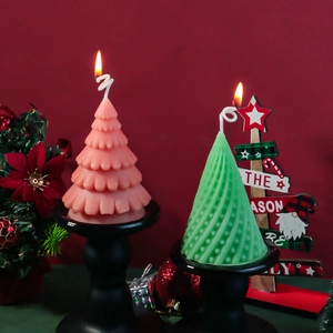 Spiral Christmas tree scented candles in pink and green on elegant black matte stands