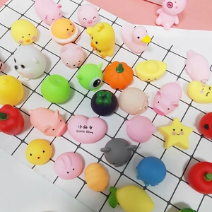 Cute pink pig and animal mochi squishy stress relief toys set on a grid background