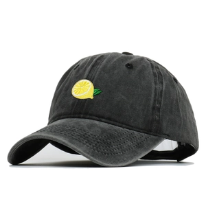 Vintage washed dark grey cotton baseball cap with yellow lemon embroidery on white background