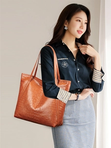 Brown crocodile pattern tote bag shown by a model for professional styling and daily use