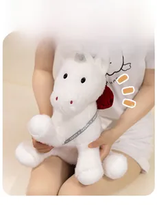 White unicorn plush doll with silver horn and Lucky ribbon held by a model