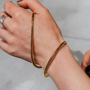 Elegant gold titanium steel open bangle featuring a minimalist curved polished design
