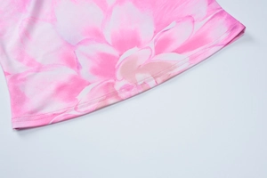 Detailed close-up of the double-needle hem on a pink floral print crop top for women