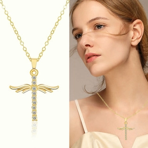 Detailed macro view and model shot of golden winged cross necklace with sparkling crystals