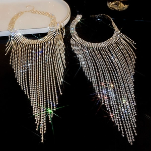 Detailed view of luxury gold and silver long tassel necklaces with sparkling rhinestones