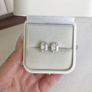 Detail view of emerald-cut square cubic zirconia earrings in a velvet jewelry box