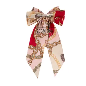 Elegant satin bow hair clip with floral gold chain print and 20cm long ribbon streamers