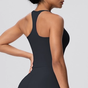 Detail of black racerback sports bra with thin straps and breathable tight fit fabric