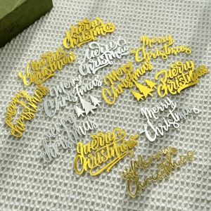Glossy gold and silver Merry Christmas acrylic cake toppers with festive patterns