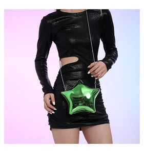 Detailed view of the green star-shaped acrylic clutch with metallic chain and snake skin dress