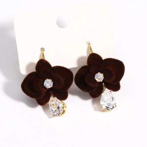 Detail of red floral earrings with velvet petals and hanging crystal drop on white card