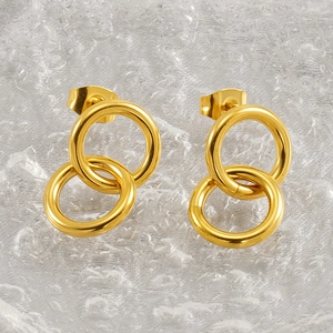 Macro view of gold interlocking geometric hoops showing polished finish and stud backing