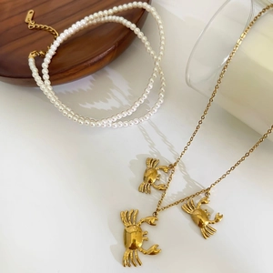 Layered pearl necklace and gold crab pendant necklace set in minimalist style