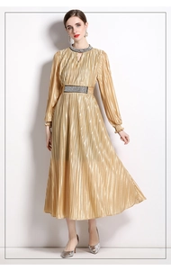 Detailed view of luxury pleated gold dress with intricate beadwork and waist crystals