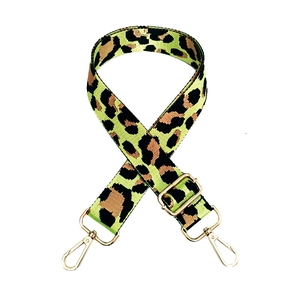 Macro view of leopard print nylon strap with polished gold hardware and swivel hooks