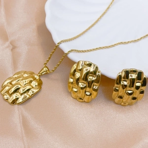 Elegant gold shell necklace and earrings set with quilted texture on champagne silk fabric