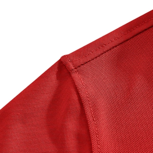 Close-up of breathable red mesh fabric and reinforced double-stitching on a men's polo shirt