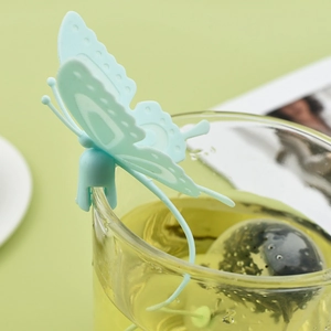Creative butterfly shaped tea infuser in light green silicone hanging on glass rim