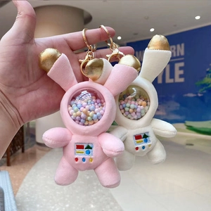 Close-up of cute plush astronaut bunny keychain with colorful beads in clear helmet