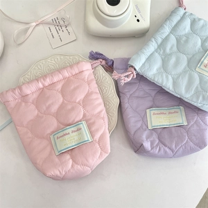 Quilted drawstring storage bags in pink, purple, and blue colors for small cameras