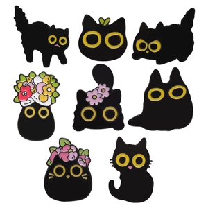 Set of 8 cute black cat enamel pins with floral accents and yellow eyes on white background