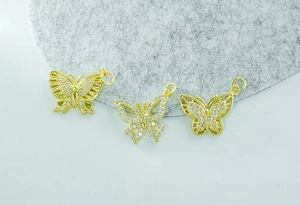Macro shot of 18K gold plated butterfly pendants with micro-paved cubic zirconia details