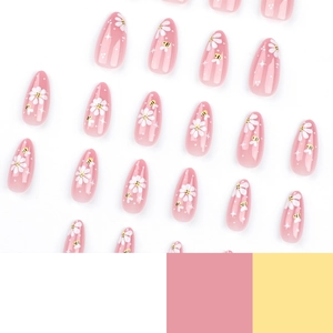 Almond press-on nails featuring yellow bees, white flowers and star motifs on pink base