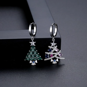 Elegant Christmas tree stud earrings with green and colorful zircons in dark macro view