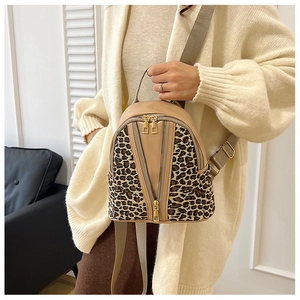 Detail of khaki and leopard print backpack with gold zippers and V-shape pockets