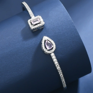 Detail view of pink crystal open bracelet with teardrop and rectangle stones and micro pavé