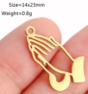 Makroaufnahme des goldenen Gebetshände-Anhängers zeigt 14x23mm Größe auf Finger