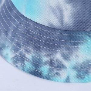 Detailed close-up of blue tie-dye bucket hat with reinforced stitching on the brim