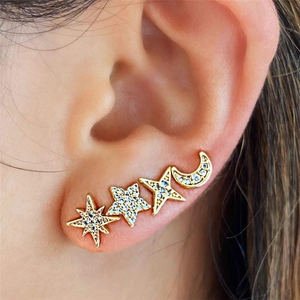 Close-up of golden star and moon ear crawler set with sparkly white cubic zirconia