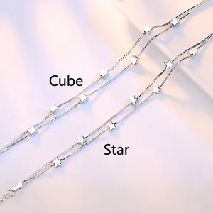 Silver double-layer snake chain bracelet with star and cube pendants for women