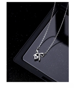 Macro shot of S925 sterling silver bow heart pendant with sparkling cubic zirconia