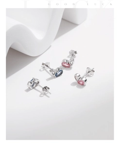 Detail showing S925 hallmark on silver stud earrings with pink and blue heart stones