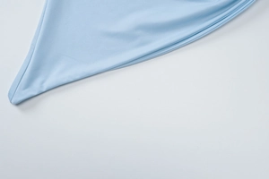 Close-up of light blue ribbed knit fabric showing fine stitching and premium texture