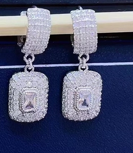 Silver square zircon drop earrings with micro-pave crystals on wooden stand