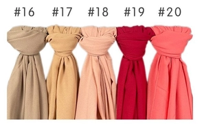 Detailed selection of five solid color pearl chiffon scarves from beige to coral red