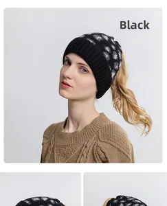 Macro detail of black knit ponytail beanie with leopard jacquard and top opening design