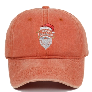 Close-up of Santa Claus embroidery and Merry Christmas text on washed orange cotton cap