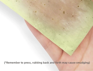 Detail of a single translucent linen oil-absorbing sheet showing fine fiber texture