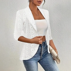 Detailed texture of white lace hollow-out cardigan with elegant knit patterns