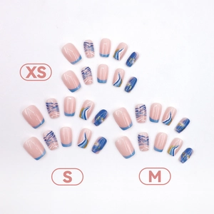 Blue and white marble press-on nails with gold foil and water ripple patterns