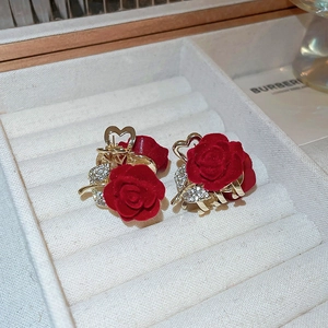 Macro shot of flocked red rose hair claw clips with gold heart base and inlaid crystals